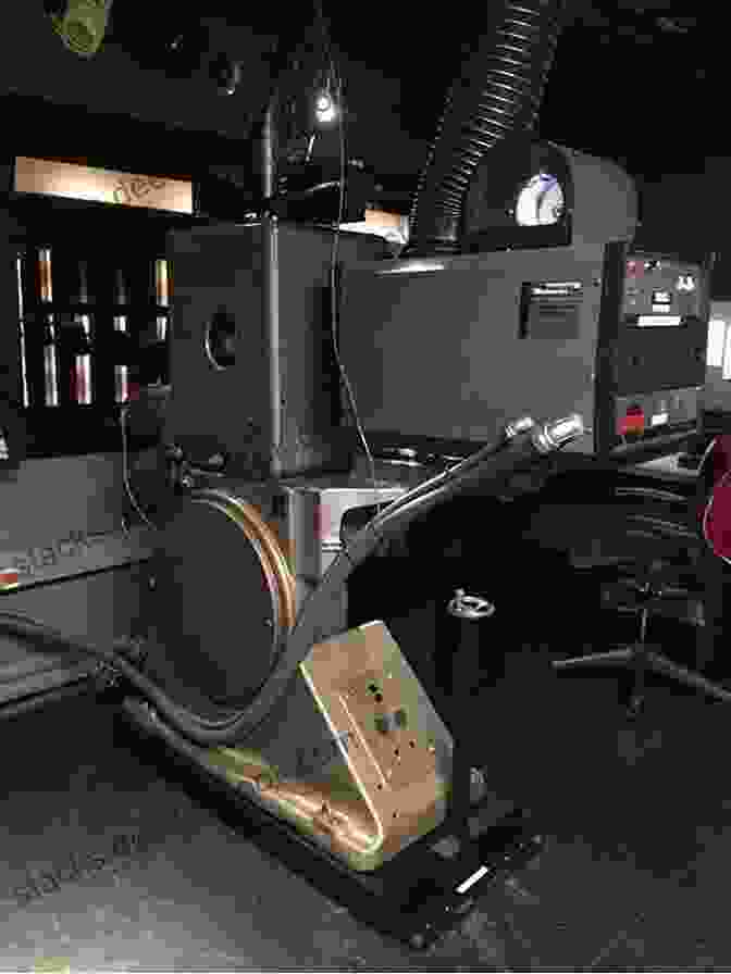 A Technician Adjusting A Film Projector Before A Theatrical Screening 10 Tips For Setting Up Theatrical Screenings For Your Film